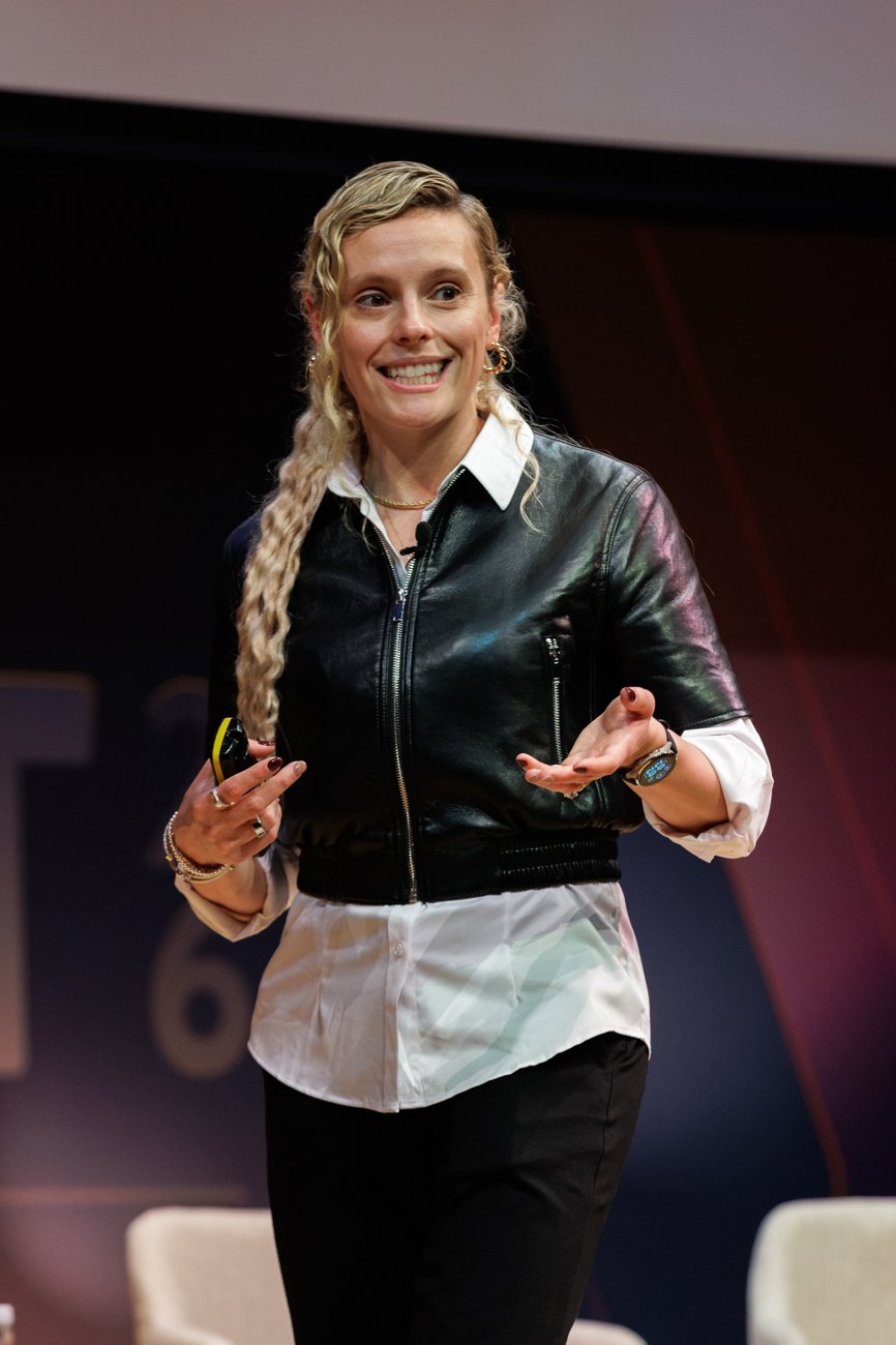 Lauren Livak Gilbert speaking on stage in a black jacket